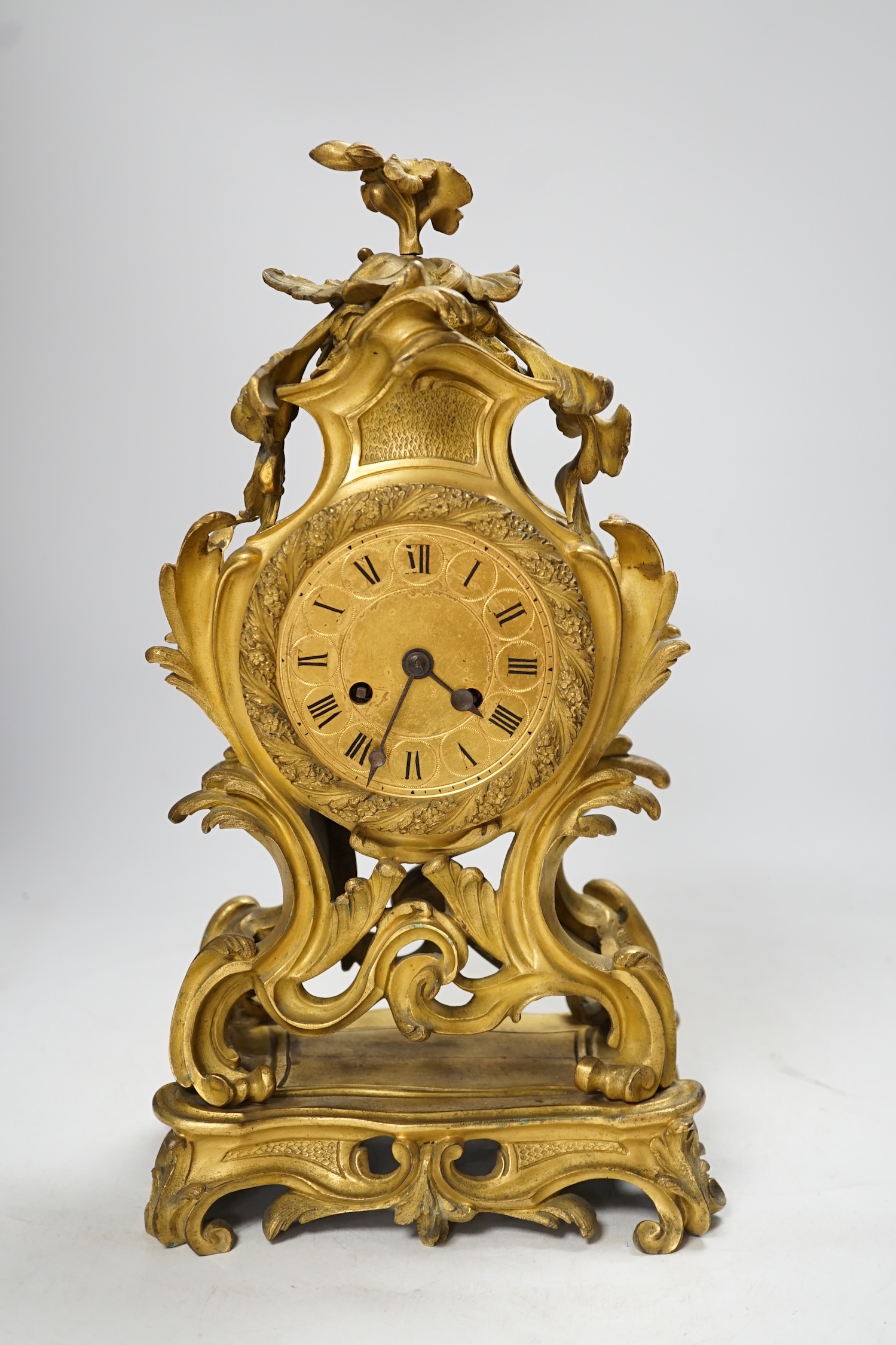 A 19th century French gilt metal mantel clock with Roman numeral dial, no key, pendulum a.f, 35cm high. Condition - fair